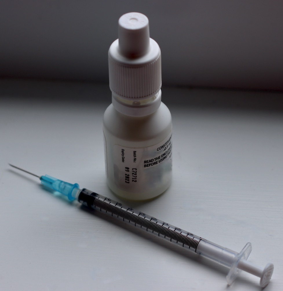 Photo of syringe and bottle